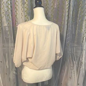 Gently used cream colored sheer blouse with gemstone embroidery around the neck